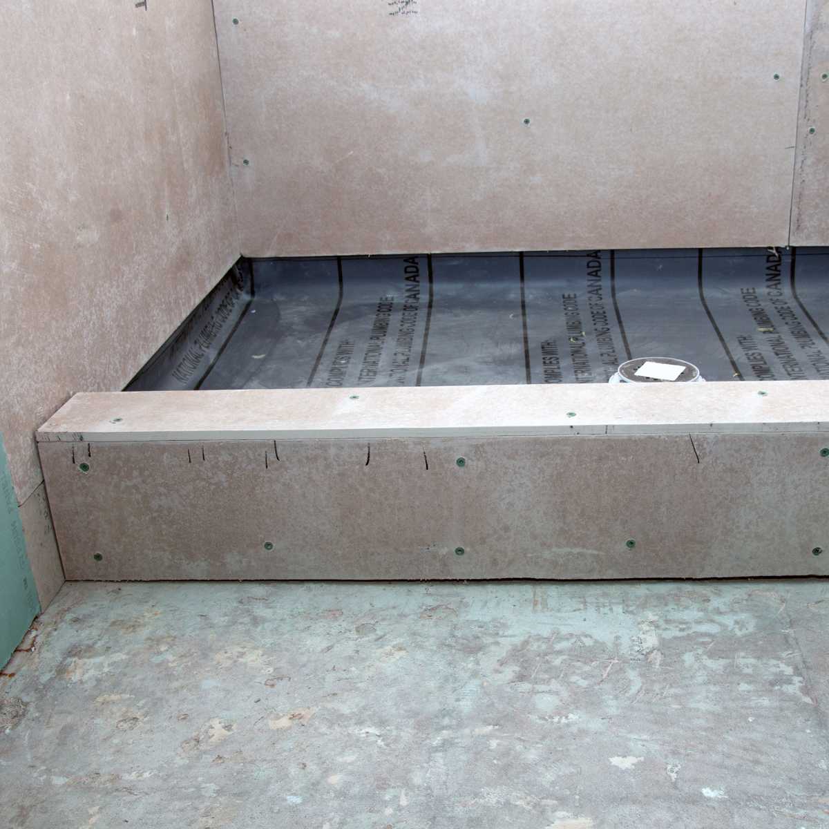 glue shower pan liner to concrete